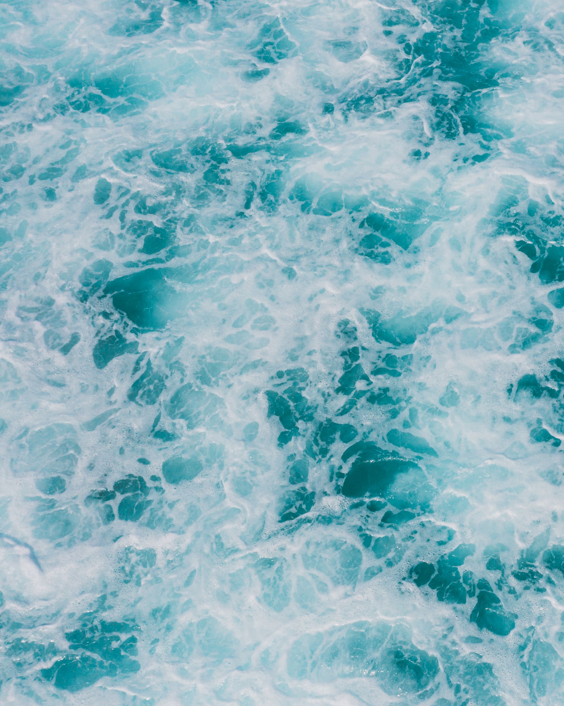 Sea foam patterns on turquoise water